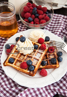 Belgian waffles with whipped cream and fresh berries