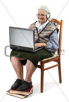 Senior woman using laptop computer isolated on white