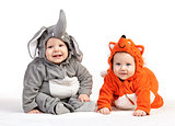 Two baby boys dressed in animal costumes over white
