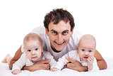 Smiling young man with two baby boys over white