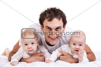 Smiling young man with two baby boys over white