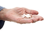 Closeup of senior hand holding medications