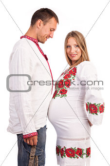 Young couple in Ukrainian style costumes over white