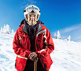 Senior woman wearing ski jacket and goggles on snowy slope in mountains. With clipping path.