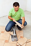 Worker cutting ceramic floor tiles