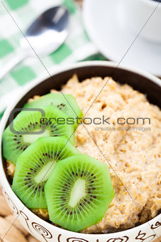 Bowl of oats porridge with kiwi