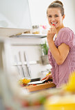 Portrait of happy young woman in kitchen