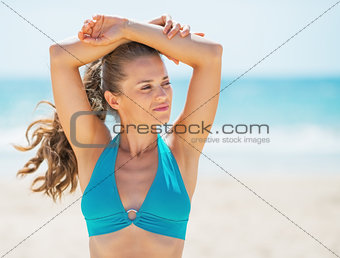 Portrait of thoughtful young woman on beach looking on copy space