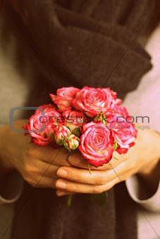 bouquet of pink roses in female hands