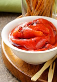 grilled red bell pepper in a white bowl on wooden table