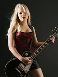 Blond woman playing electric guitar