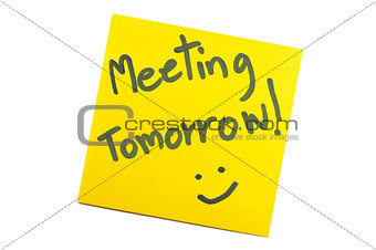 Sticky note with text "Meeting Tomorrow"