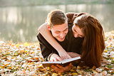 young couple lying down reading