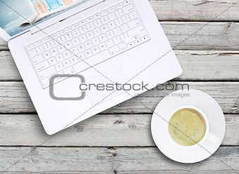 Laptop and a cup of coffee with crema