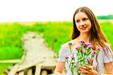 portrait of a beautiful girl with a bouquet on a background of f