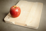 apple on wooden cutting board