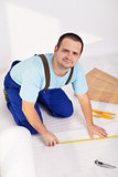 Man laying laminate floor at home
