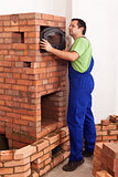 Worker building a masonry heater