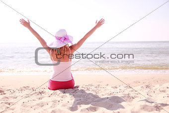girl wearing hat on the beach