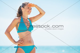 Young woman on beach looking into distance