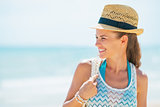 Portrait of smiling young woman in hat on beach looking on copy 