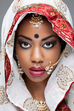 Young Indian woman in traditional clothing with bridal makeup and jewelry