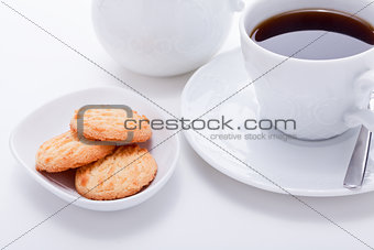 dark coffee in cup homemade cookie on table