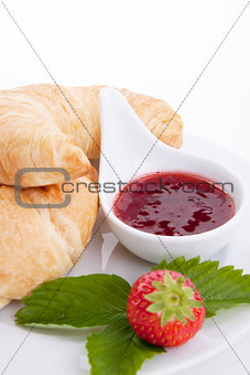 deliscios fresh croissant with strawberry jam isolated