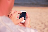 man with phone on the beach