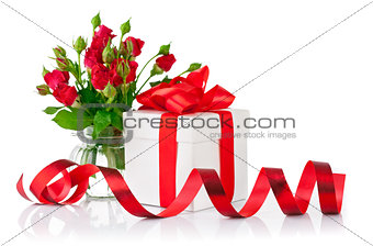 Gift with red bow and bouquet rose