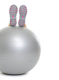 Closeup on woman legs on fitness ball