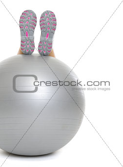 Closeup on woman legs on fitness ball