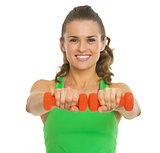 Happy fitness young woman making exercise with dumbbells