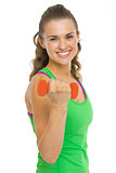Smiling fitness young woman making exercise with dumbbells