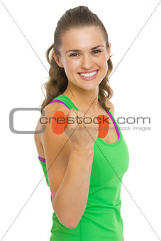 Smiling fitness young woman making exercise with dumbbells