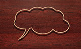 blank recycled paper speech bubble on wood background