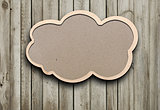 blank recycled paper speech bubble on wood background 
