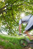 Cyclist in blurred motion riding a bike in a forest
