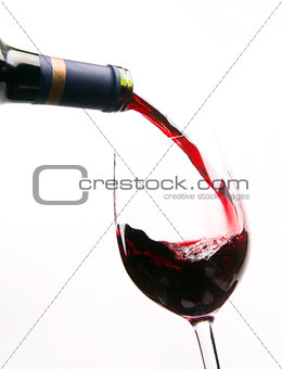 Red Wine Being Poured into Stemmed Glass