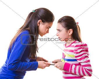 Teen girls fighting for digital tablet