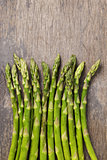 bunch of fresh green asparagus on old wood board