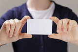 female teen hands holding business card