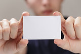 adult man hand  holding empty business card in front of camera