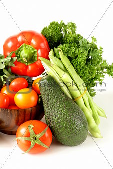 various vegetables (avocado, cucumbers, parsley, bell pepper, tomato)