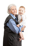 Portrait of a senior grandmother holding grandson over white