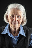 Portrait of a calm senior woman looking at the camera. Over black background.