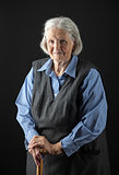Portrait of a smiling senior woman looking at the camera. Over black background.