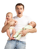 Smiling young man with two baby boys over white