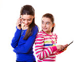 Happy teen girls with digital tablet and smartphone