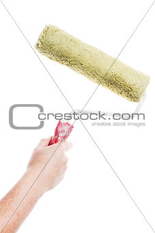 Hand holding paint roller 